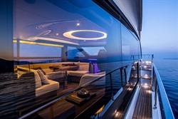 Luxurious 2025 Absolute 52 FLY yacht with elegant interior and ocean view at sunset.